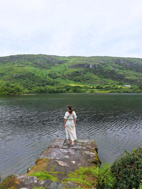 lady overlooking gougane barra lake