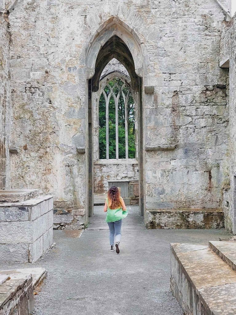 lady running muckross abbey killarney